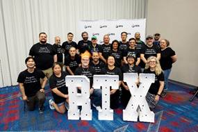 Group photo in front of RTX letter sign. 